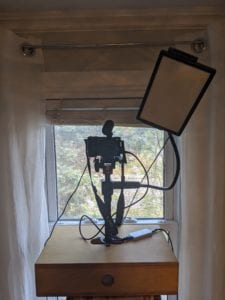 A camera stand with light and microphone