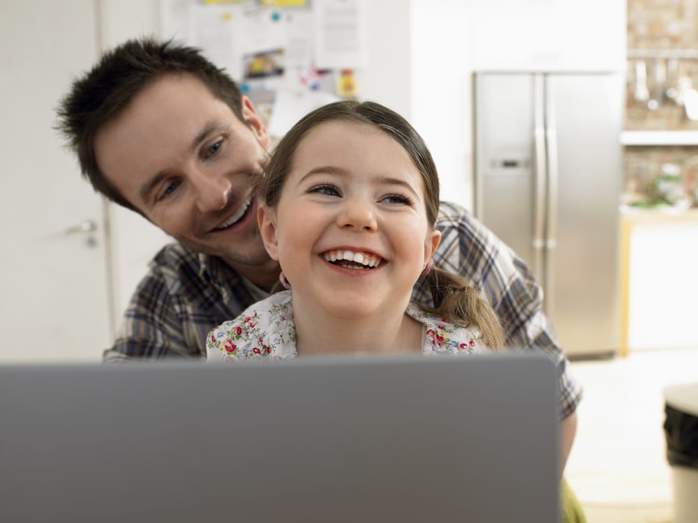 A father and daughter reviewing her digital portfolio application